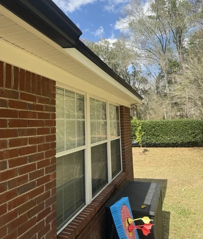 After: fascia, soffit, and gutter exterior cleaning on a red brick home
