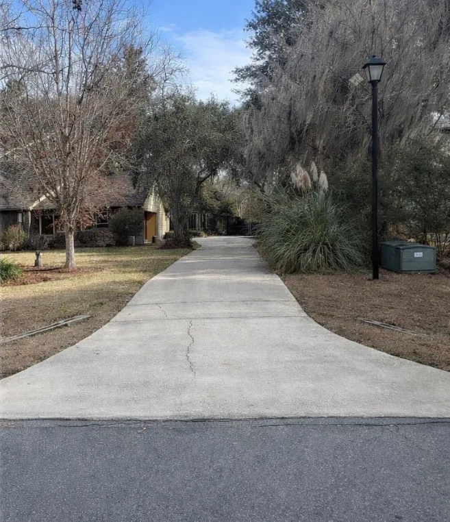After: residential driveway cleaning on a long concrete driveway